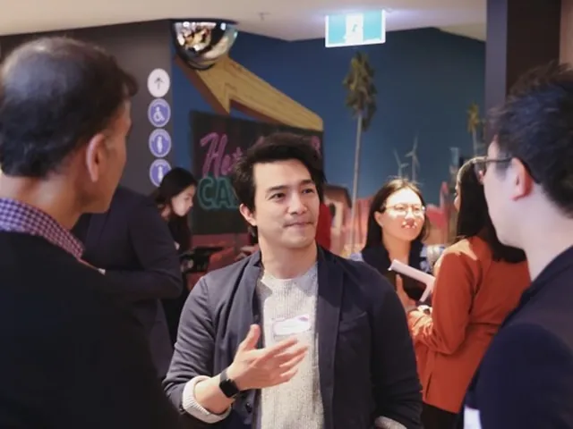 Michael chatting with attendees at a tech networking event